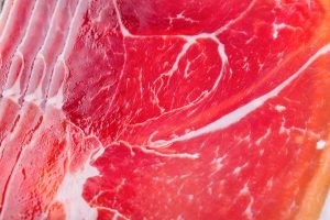 pieces cut red meat lie each other