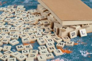 wooden dice with letters them pages book